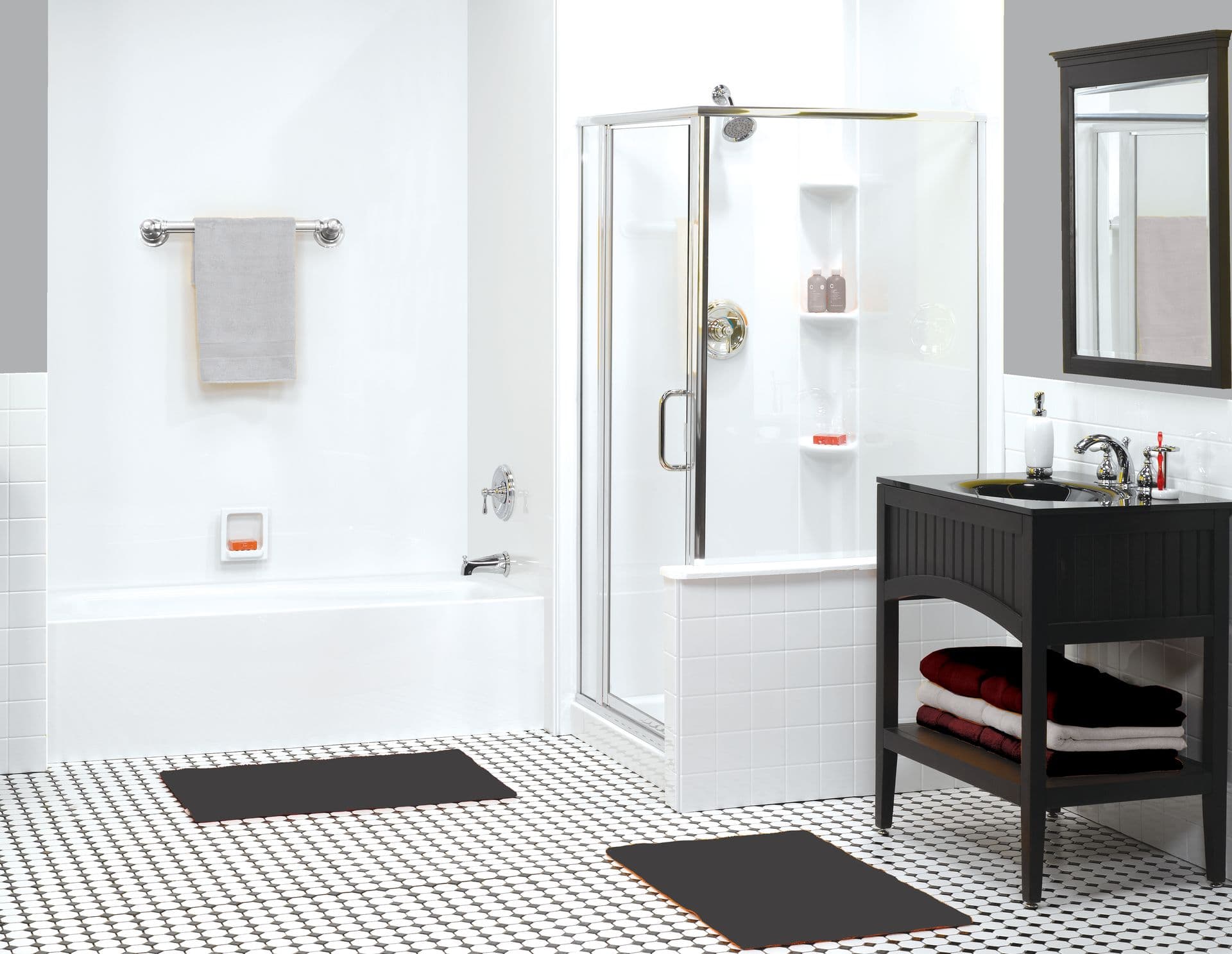 Modern bathroom with white fixtures, including a bathtub and glass shower. A vanity with a mirror and towels adds a touch of elegance.