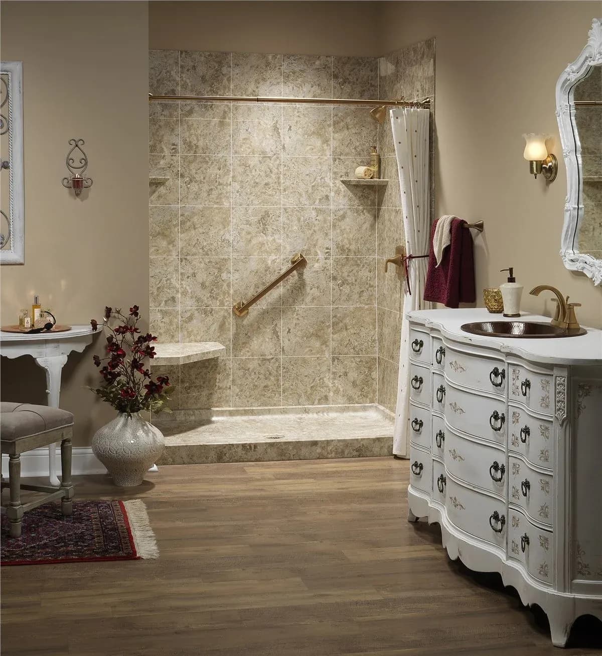 Elegant bathroom with a marble-tiled shower, bronze grab bar, and ornate white vanity. The room features warm lighting and a classic, cozy decor.